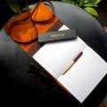 Open notebook with pen, leather wallet
