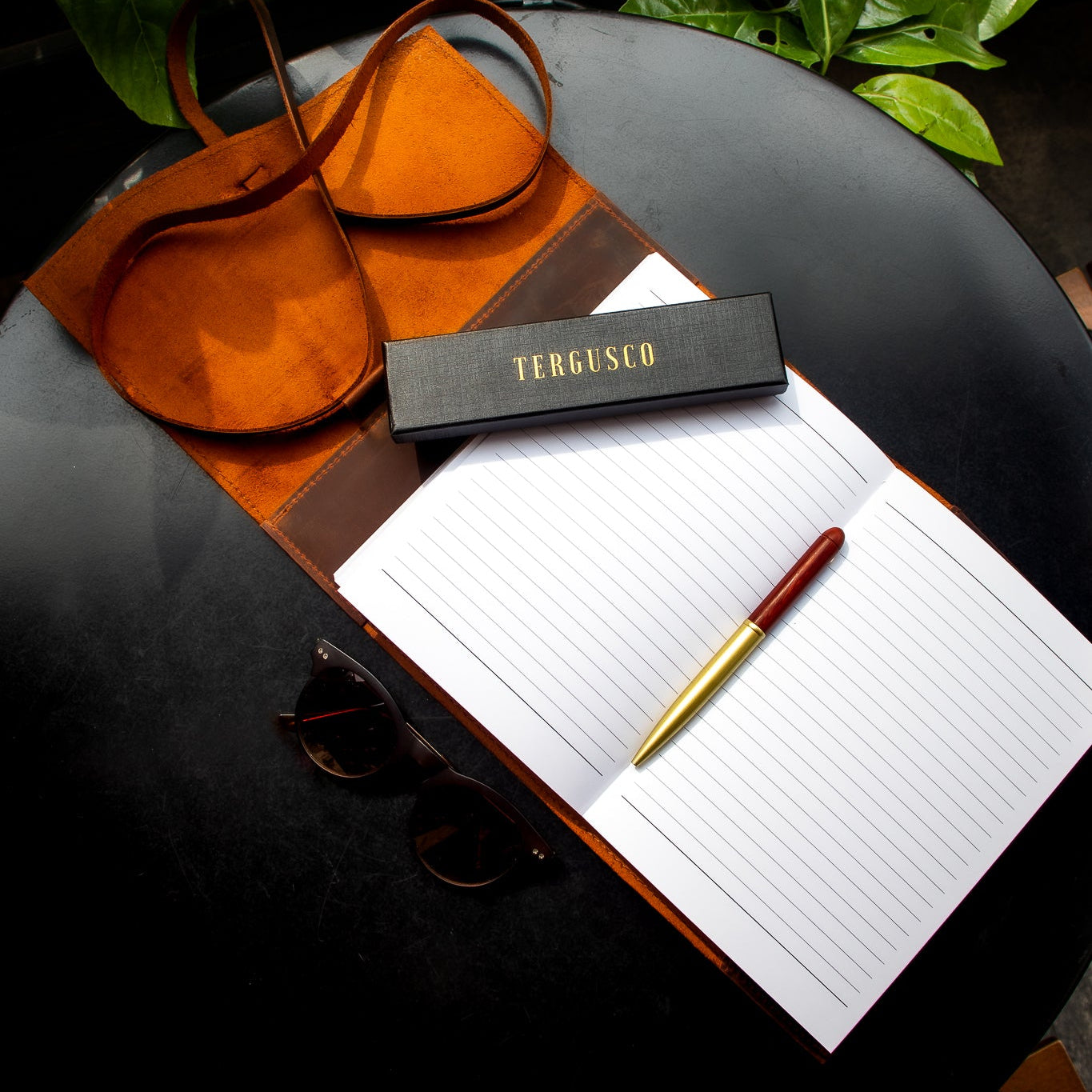 Open notebook with pen, leather wallet